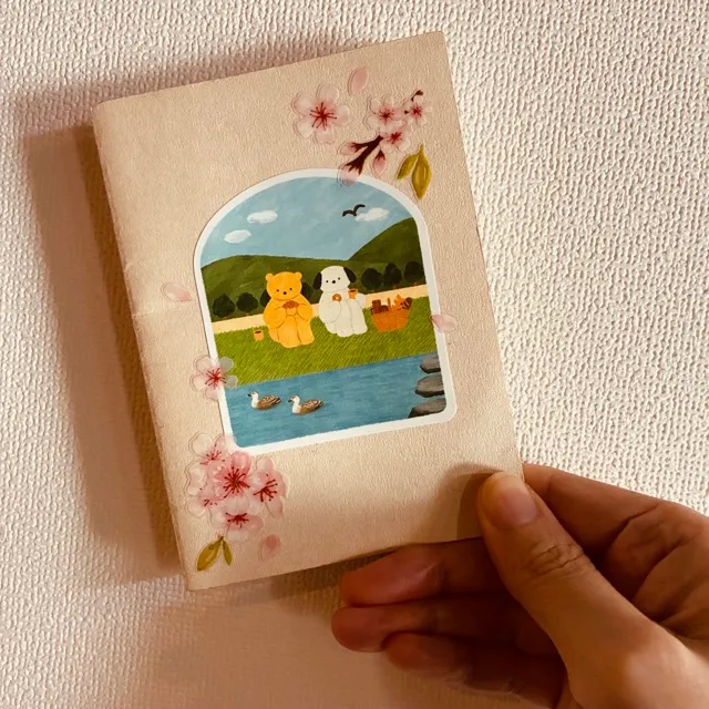 Cherry blossom stickers all over the cover of the Traveler's Notebook