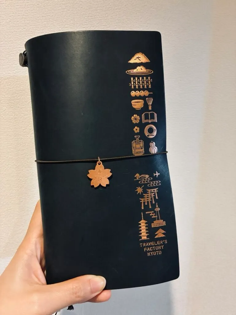 The Traveler's Notebook with a Japanese-pattern cover and a cherry blossom tag